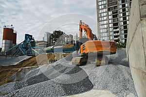 Large orange excavator working on a gravel on construction site. Details of industrial excavator. Big excavator standing