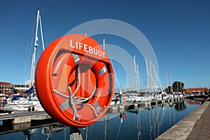 Large orange lifebuoy in Weymouth harbour