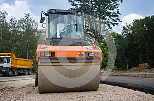 Large orange roller on road paving works