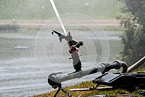 Large outdoor sprinkler surrounded by mist