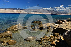 Large oval stones in crystal clear water on Sveta Maria beach on Pag island, Croatia.