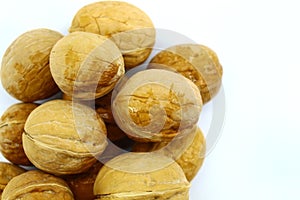 Large oval whole walnuts on white background