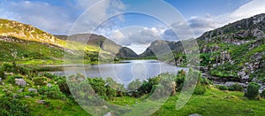 Large panorama with Black Lake valley and mountains at sunset in Gap of Dunloe, Black Valley