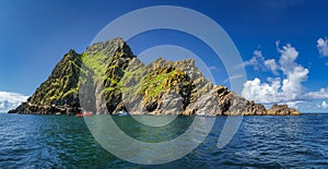 Large panorama with cruise boats docking to Skellig Michael island, where Star Wars were filmed