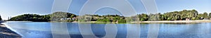 Large panoramic image of a lake in bright sunny day