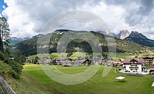 Large panoramic view of Pozza di Fassa, a commune at the northern Italia