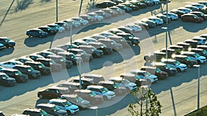 Large parking lot of local dealer with many brand new cars parked for sale. Development of american automotive industry