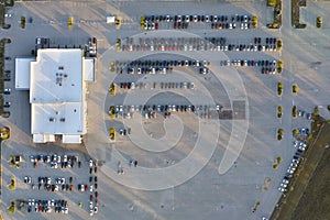 Large parking lot of local dealer with many brand new cars parked for sale. Development of american automotive industry