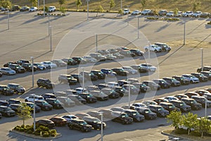 Large parking lot of local dealer with many brand new cars parked for sale. Development of american automotive industry