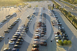 Large parking lot of local dealer with many brand new cars parked for sale. Development of american automotive industry