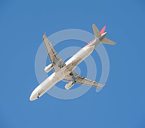 Large passenger aircraft in flight against blue sky