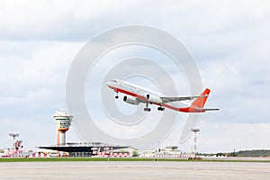 Large passenger airplane takes off at airport.