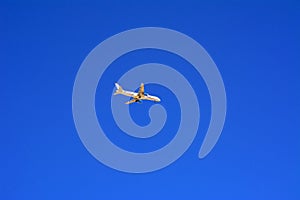 A large passenger plane flies high in the blue sky. Vacation, tr