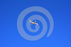 A large passenger plane flies high in the blue sky. Vacation, tr