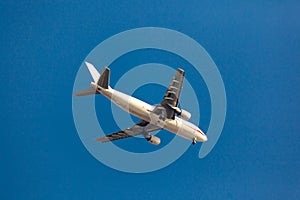 Large passenger plane flying in the blue sky