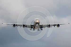 Large passenger plane landing on the airport during stormy weather