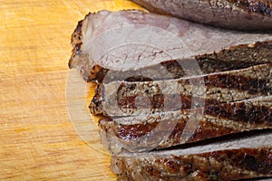Large piece of fresh beef meat prepared on a grill pan on light
