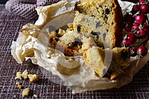 A large piece of homemade pie with prunes filling. orange and Apple, cut on parchment paper. Porous pastry like photo