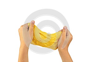 A large piece of yellow slime in the hands of a child isolated on a white background.