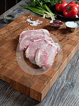 Large pieces of chopped pork meat on a beautiful wooden board