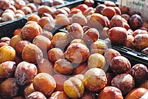A Large Pile of Amigo Pluots at the Farmers Market
