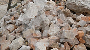 Large pile of building bricks or the remains of a destroyed building in a heap at a construction site