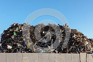 Large pile of collected scrap metal on the territory of the metal collection point. Recycling for recycling