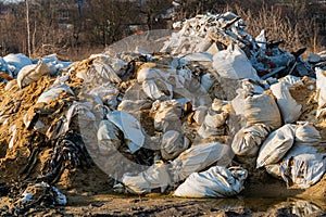 A large pile of construction debris at a landfill. Dump of various waste. Illegal dump. Negative impact on nature. Waste dump