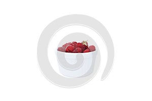 Large pile of fresh raspberries in white bowl isolated on white background