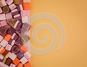 A large pile of mixed sweets on  background