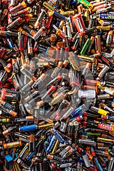 Large pile of old, used, corroded batteries at a recycling centre