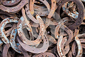 Large pile of rusty used Horseshoes