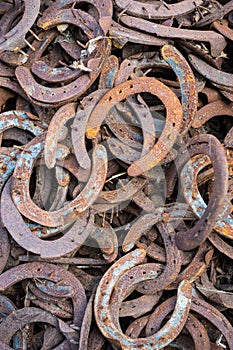 Large pile of rusty used Horseshoes