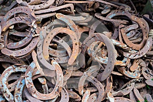 Large pile of rusty used Horseshoes