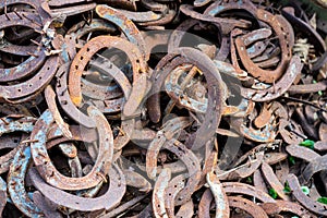 Large pile of rusty used Horseshoes