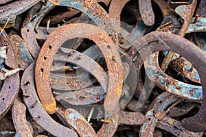 Large pile of rusty used Horseshoes