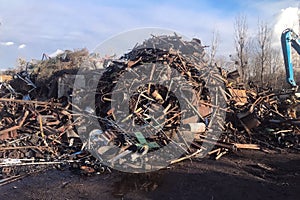 A large pile of scrap metal awaits processing, metal sorting