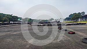 a large pile of used tires stacked in a haphazard way on a paved parking lot photo