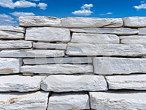 A large pile of white stone blocks against a blue sky photo