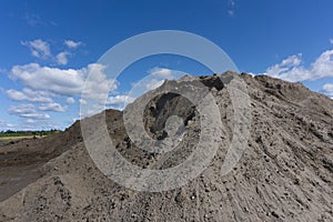 Large piles of construction sand and gravel used for asphalt production and building. Limestone quarry, mining rocks and stones .