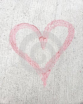 Large pink chalk heart on cement