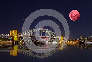 Large Pink moon rising behind Sydney CBD buildings NSW Australia