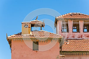 Large pink ruined mansion from Portuguese colonial times in Angola