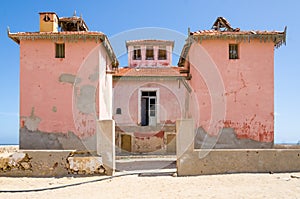 Large pink ruined mansion from Portuguese colonial times in Angola photo