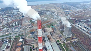 Large pipes smoking in a industrial area. Thermal power plant. Aerial.