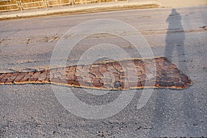 A large pit on the road, laid with old bricks.  The repair of the road without a monetary investment. Life hack