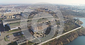 Large plant near the lake, beautiful nature. Industrial buildings top view. Metalwork factory top view.