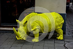 A large plastic rhino figure, a symbol of confidence and fearlessness