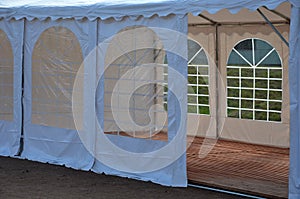 A large plastic tent used as a temporary shelter for entertaining guests at weddings and concerts and parties. party or coronaviru