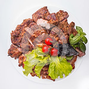 A large plate of meat assorted cooked on a grill